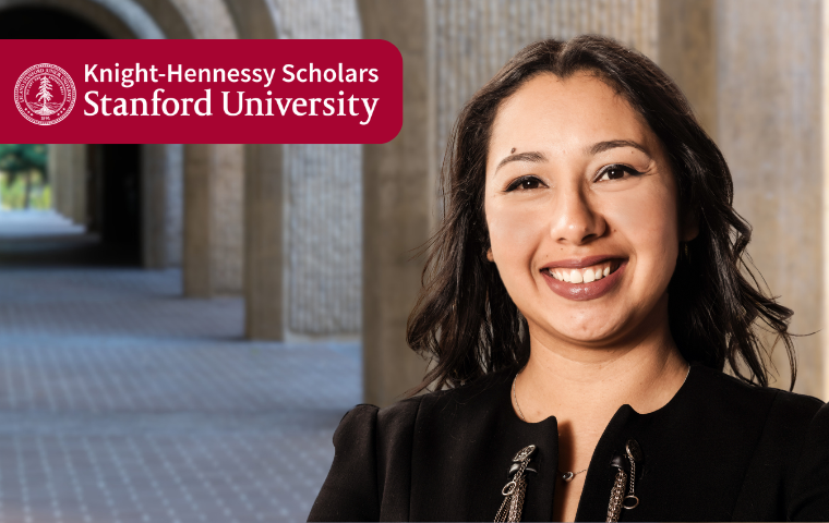 Young woman with shoulder length brown hair smiling, standing on walkway of Stanford's campus. On the picture, a graphic that reads Stanford University Knight Hennessy Scholars
