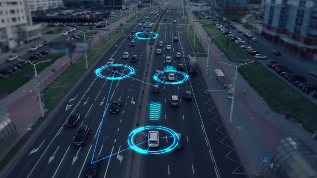 Overhead view of cars driving on highway with digital markers on the cars, analyzing their movement.