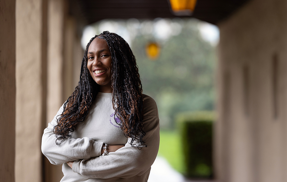 Hydeia Wysinger standing in archway outside Mission church
