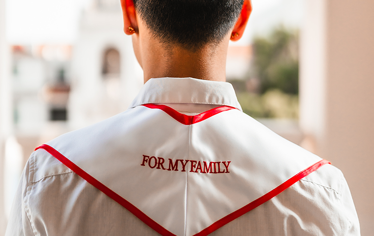 Matthew Mayo 24 wears a graduation stole honoring his family.