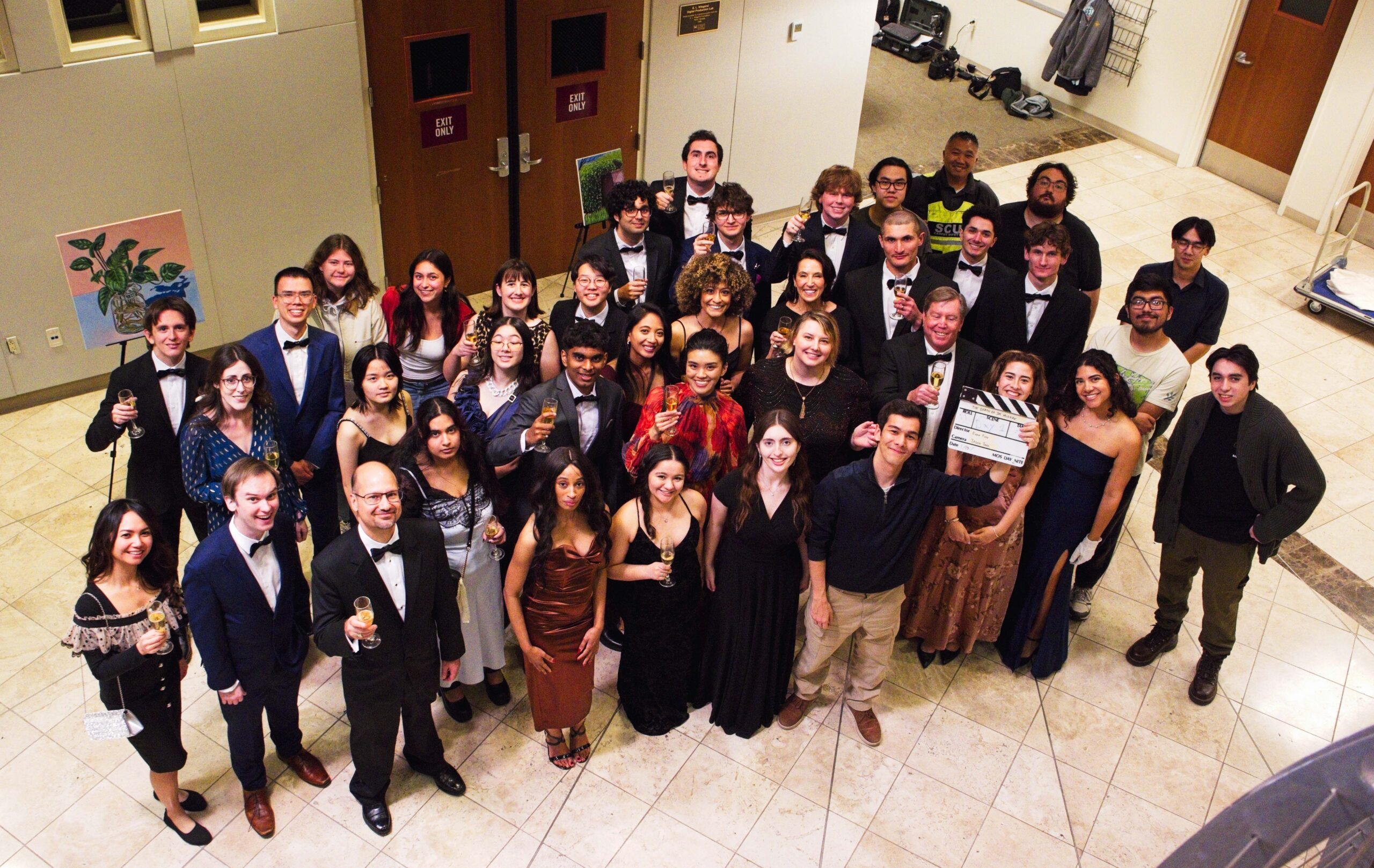 A group of roughly 35 students pose in formal wear for a photo from above.