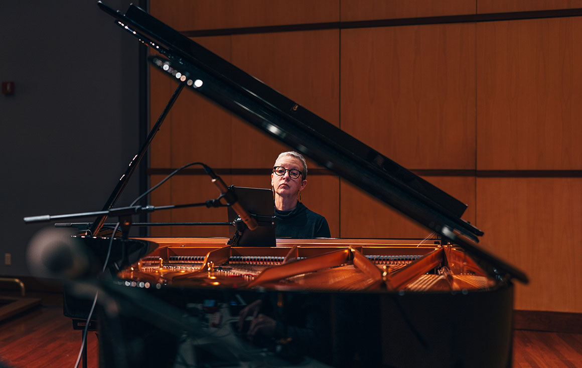 Woman plays piano.