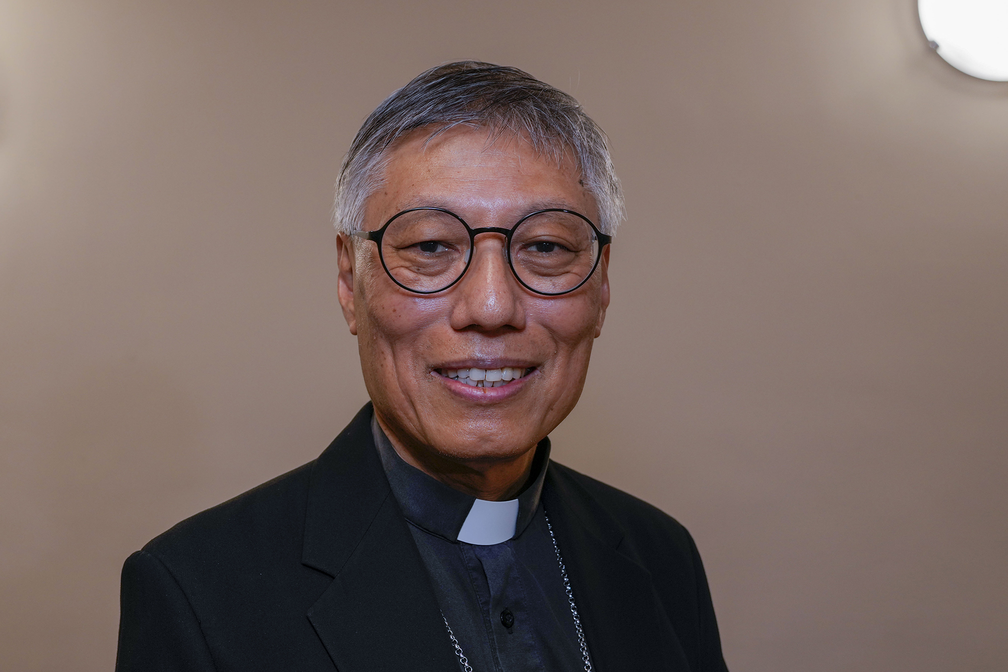 Cardinal-elect, Hong Kong Bishop Stephen Chow poses for photos during a press point at The Vatican, Thursday, Sept. 28, 2023, ahead of his elevation in St. Peter's Square at The Vatican on Saturday. (AP Photo/Domenico Stinellis)